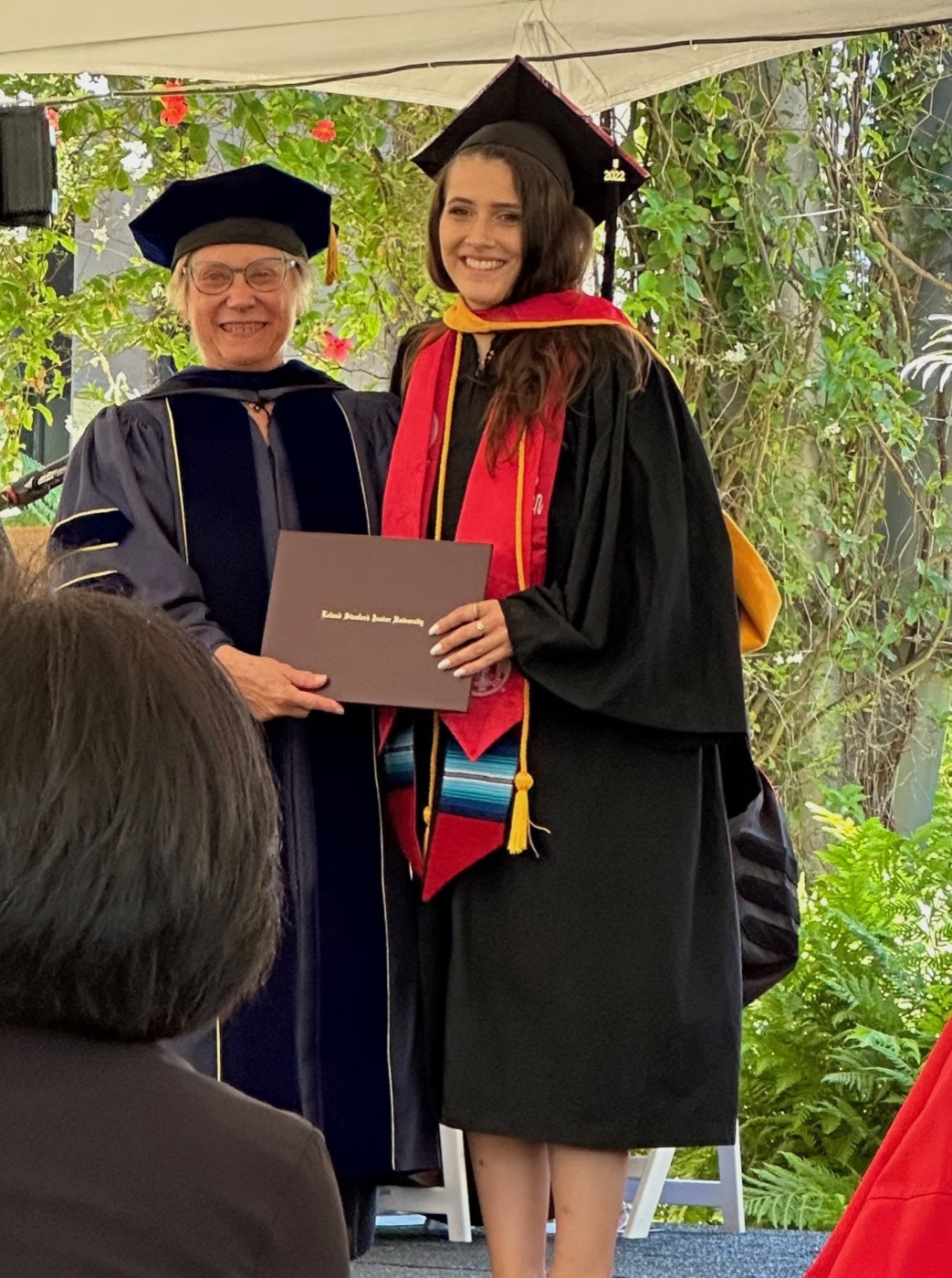 Lydia receiving her diploma at Stanford graduation
